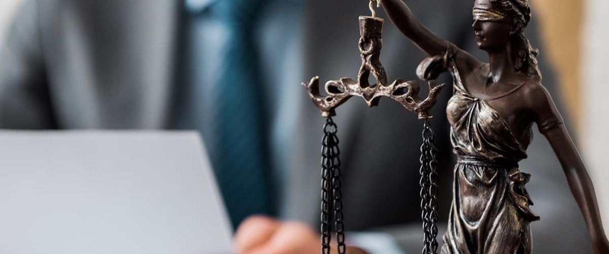 close-up-view-of-lady-justice-statue-and-lawyer-wo-RE8YGXA.jpg